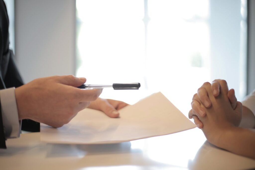 pexels-photo-3760067-1 Close-up of a contract signing with hands over documents. Professional business interaction.