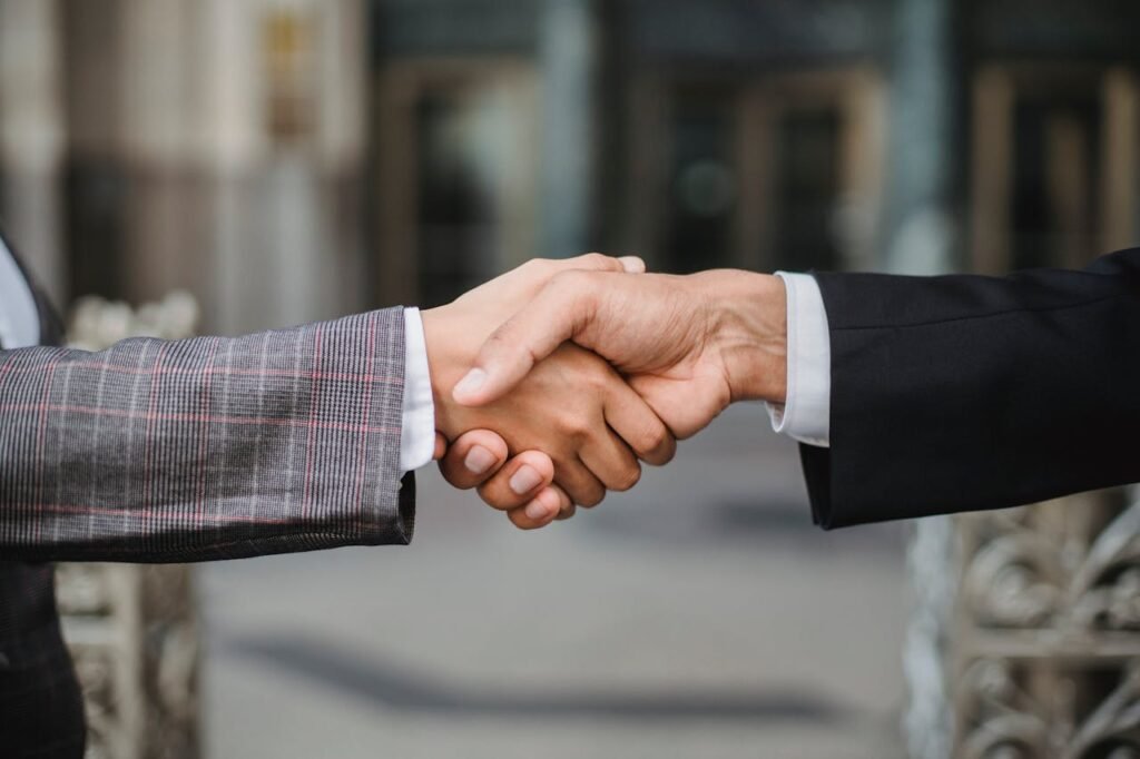 pexels-photo-4963437 A close-up of two businesspeople shaking hands, symbolizing cooperation and partnership.